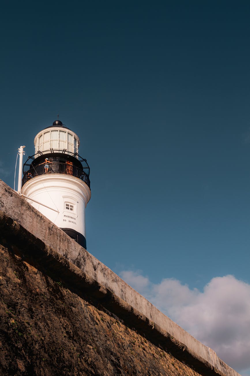 Scenic view of a lighthouse in Salvador, Brazil, under a bright blue sky.